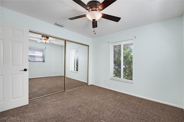 unfurnished bedroom featuring carpet floors, ceiling fan, and a closet