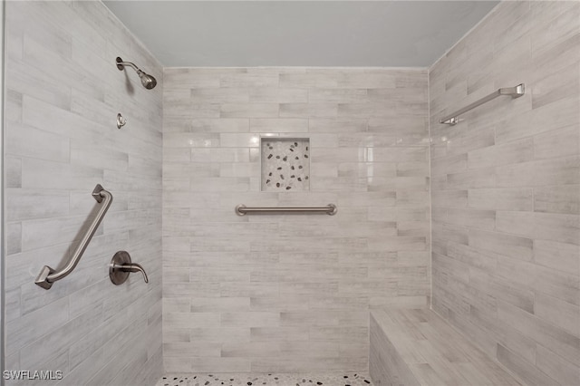 bathroom with a tile shower