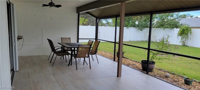 unfurnished sunroom with plenty of natural light and ceiling fan