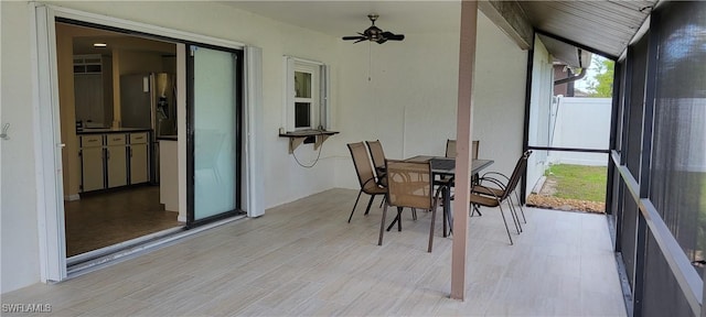 sunroom / solarium featuring ceiling fan