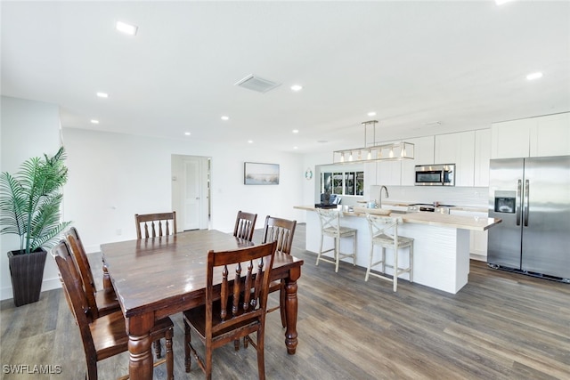 dining room with sink and wood-type flooring