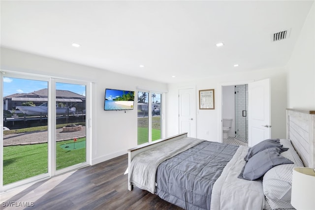 bedroom with dark hardwood / wood-style floors and ensuite bathroom