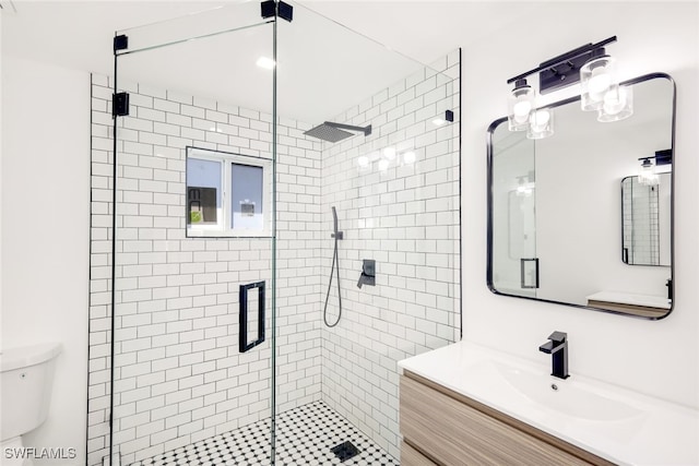 bathroom featuring vanity, toilet, and walk in shower