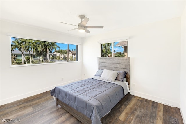 bedroom with ceiling fan and dark hardwood / wood-style floors