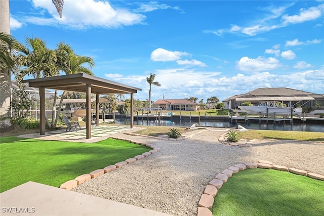 surrounding community featuring a water view and a lawn