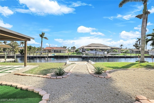 view of dock with a water view and a yard