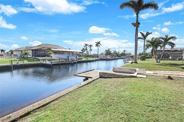 view of dock featuring a water view and a yard