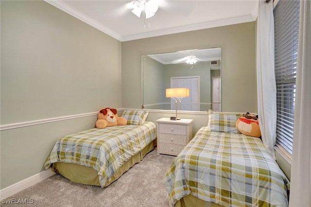 carpeted bedroom featuring ornamental molding and ceiling fan