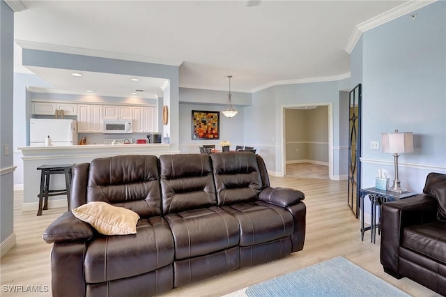 living room with crown molding and light hardwood / wood-style floors