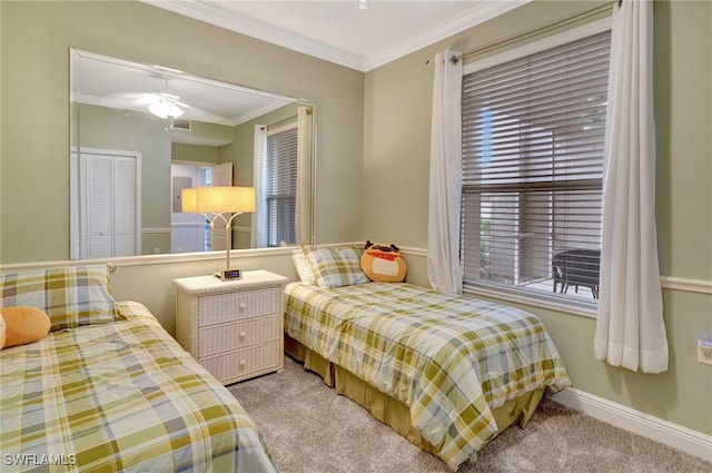 carpeted bedroom featuring ceiling fan and ornamental molding