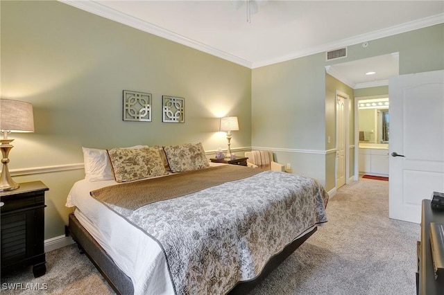 bedroom featuring ornamental molding, carpet floors, and ensuite bathroom