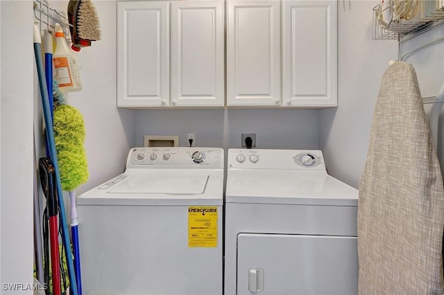 laundry area with cabinets and separate washer and dryer