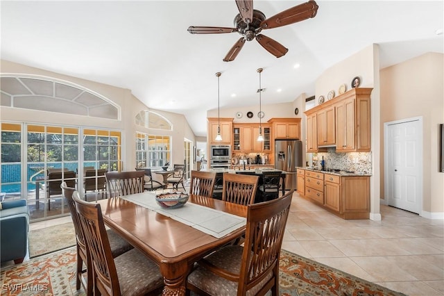 dining area with lofted ceiling, light tile patterned floors, and ceiling fan