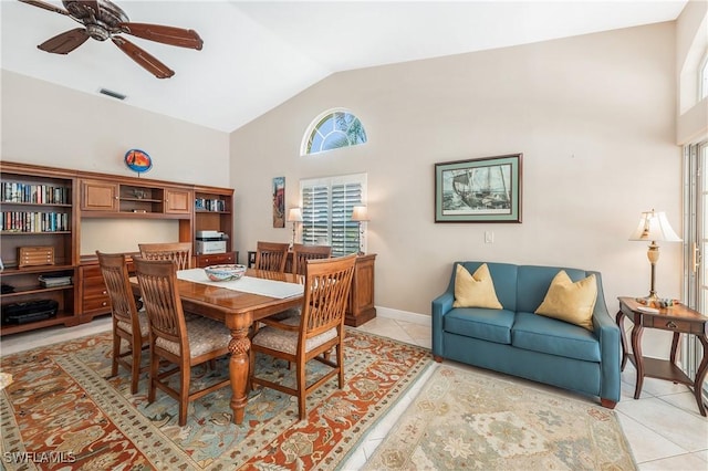 tiled dining area featuring ceiling fan, plenty of natural light, and high vaulted ceiling