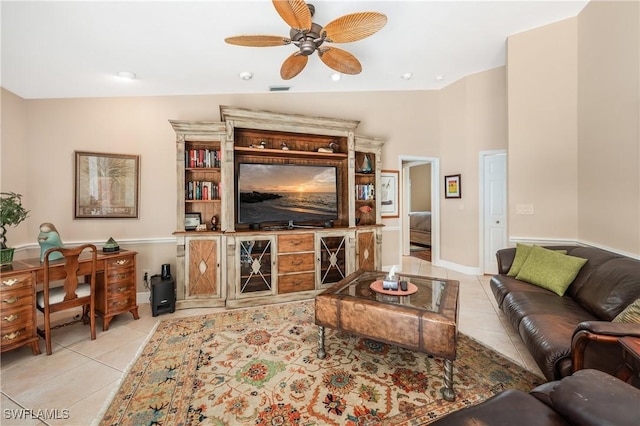 tiled living room featuring ceiling fan and vaulted ceiling