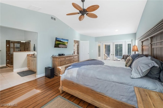 bedroom with french doors, lofted ceiling, connected bathroom, light hardwood / wood-style flooring, and access to exterior