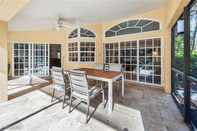 sunroom with ceiling fan and lofted ceiling