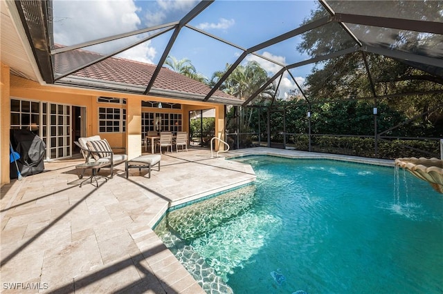 view of swimming pool with a lanai, a grill, and a patio area