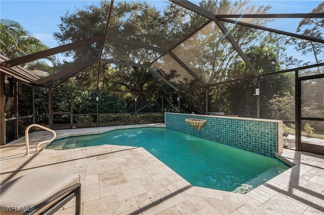 view of swimming pool with a lanai and a patio