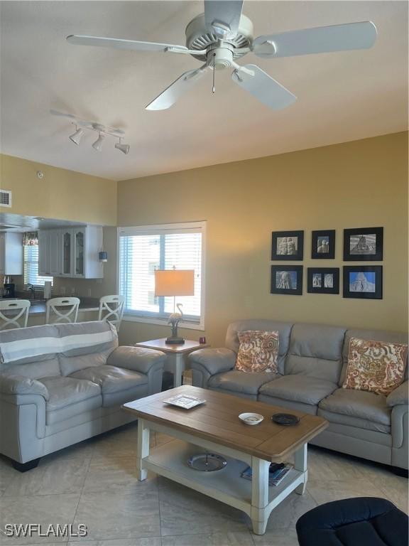 living room featuring rail lighting and ceiling fan