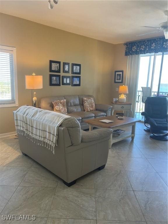 living room with ceiling fan and a wealth of natural light