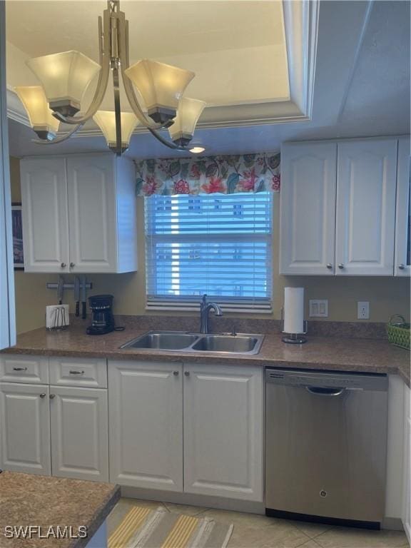 kitchen featuring sink, white cabinets, stainless steel dishwasher, a raised ceiling, and a chandelier