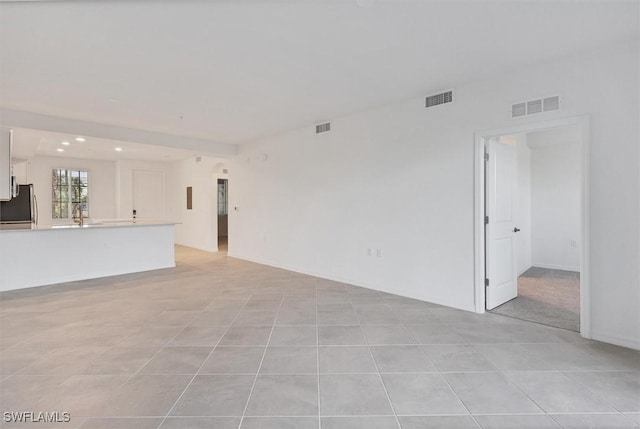 unfurnished living room featuring light tile patterned floors