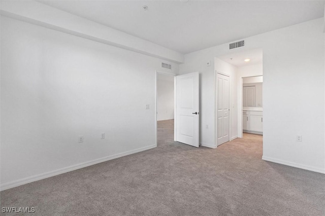 empty room featuring light colored carpet