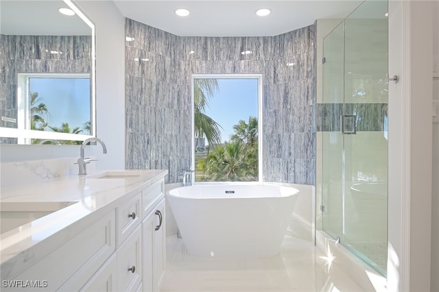 4198 Bay Beach Ln Unit 133, Fort Myers Beach, FL 33931 - full bath with tile walls, a stall shower, vanity, a soaking tub, and recessed lighting