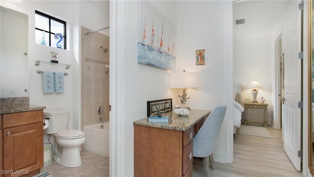 9078 Albion Ln S Unit 6603, Naples, FL 34113 - bathroom with vanity, toilet, bathing tub / shower combination, and wood finished floors