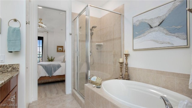 9078 Albion Ln S Unit 6603, Naples, FL 34113 - full bathroom featuring connected bathroom, a shower stall, a bath, vanity, and tile patterned flooring