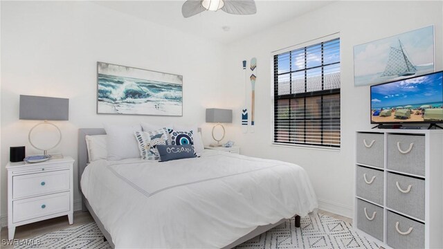 9078 Albion Ln S Unit 6603, Naples, FL 34113 - bedroom with ceiling fan, baseboards, and light wood-type flooring