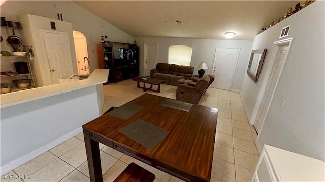 tiled dining area with vaulted ceiling