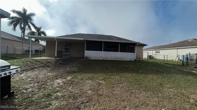 rear view of property with a lawn