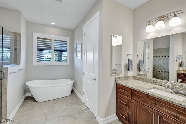 bathroom with vanity and separate shower and tub