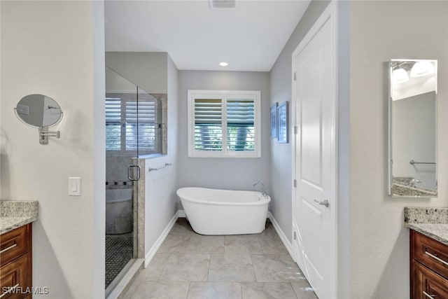 bathroom featuring tile patterned floors, vanity, and independent shower and bath