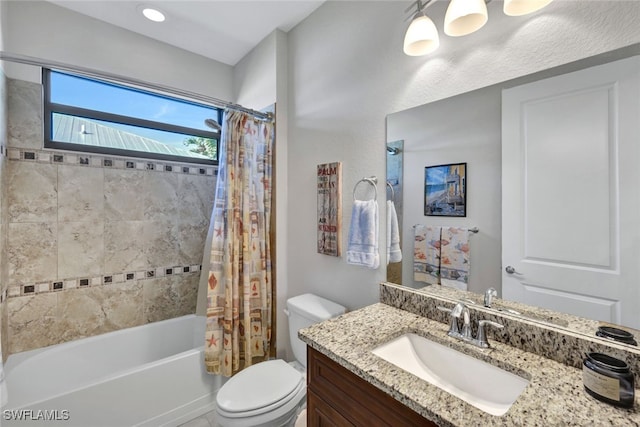 full bathroom with shower / tub combo with curtain, vanity, and toilet