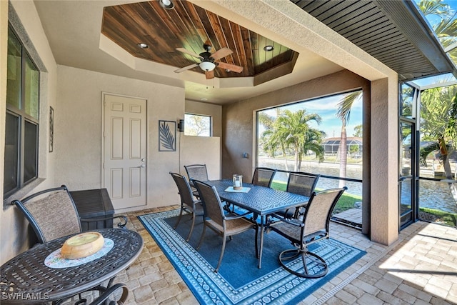 exterior space with ceiling fan and glass enclosure