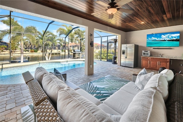 living room featuring wood ceiling, ceiling fan, and sink