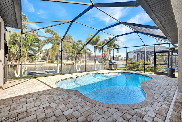 view of swimming pool with a grill, a lanai, a patio, and a water view