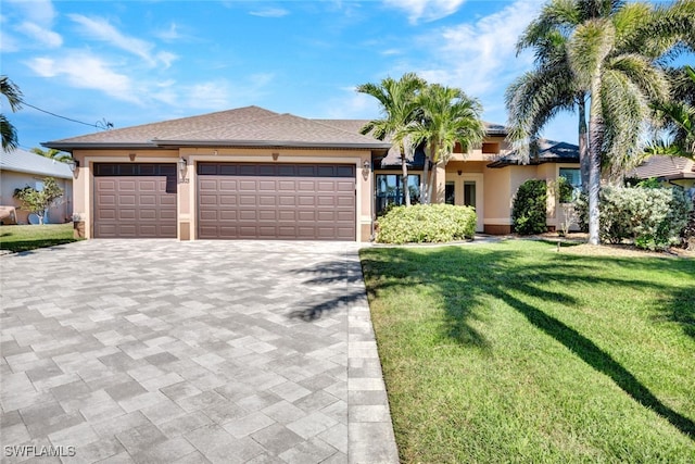 view of front of property featuring a garage and a front lawn