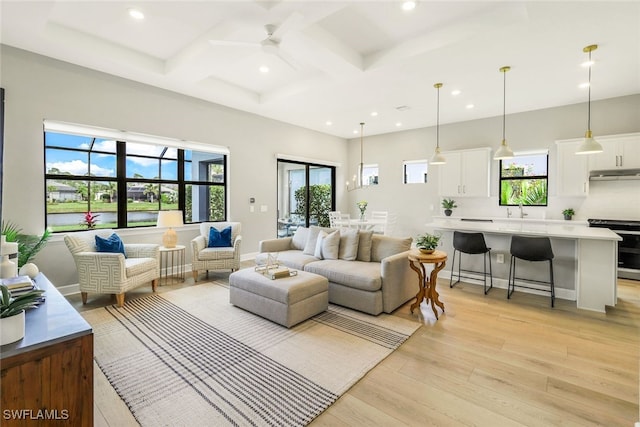 living area with baseboards, coffered ceiling, light wood-type flooring, beam ceiling, and recessed lighting