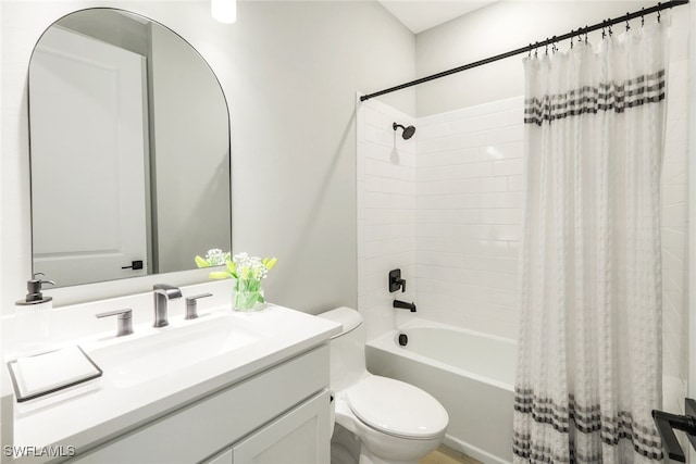 bathroom featuring shower / bath combo, vanity, and toilet