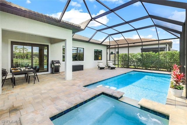 view of swimming pool featuring a lanai, a patio area, a grill, and a pool with connected hot tub