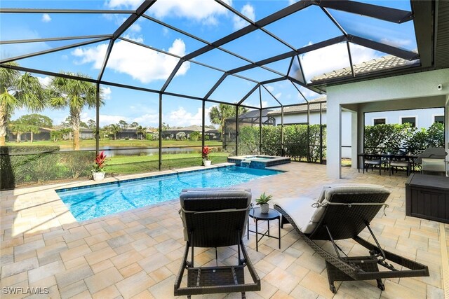 view of swimming pool with an in ground hot tub, a water view, a patio, and glass enclosure