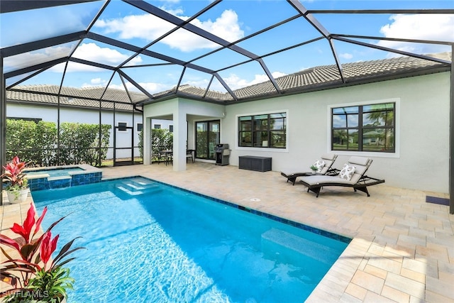 view of pool featuring a lanai, a pool with connected hot tub, area for grilling, and a patio