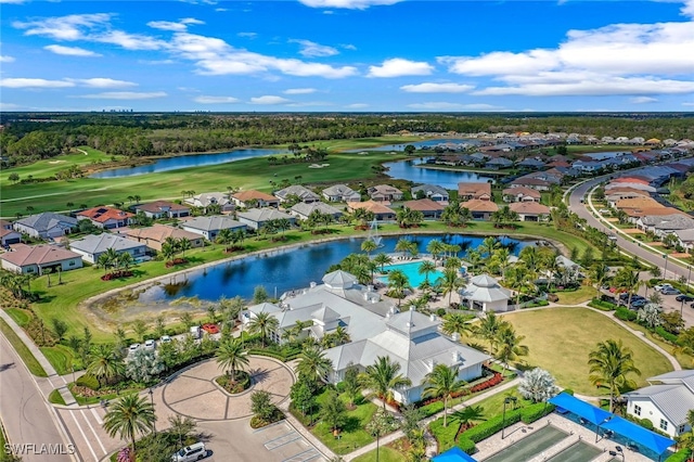 birds eye view of property featuring view of golf course, a water view, and a residential view