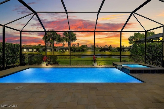 view of swimming pool with a patio area, a lanai, a pool with connected hot tub, and a water view