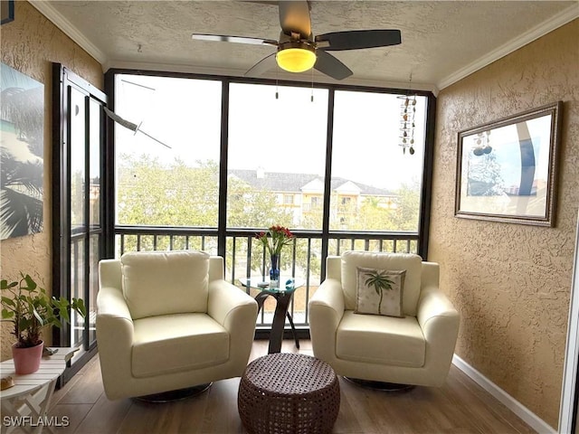 sunroom / solarium featuring ceiling fan