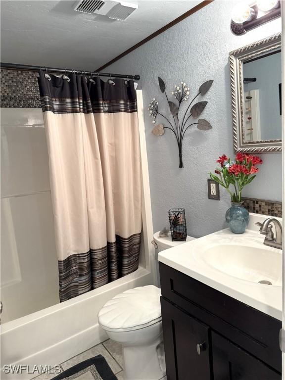 full bathroom with tile patterned flooring, toilet, crown molding, shower / bath combo, and vanity